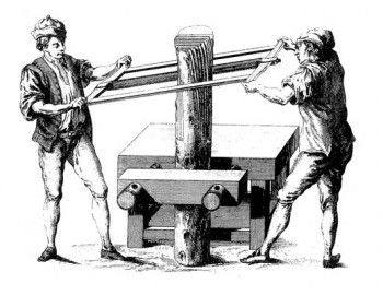 two men cutting a log into veneers by hand